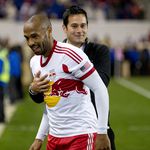Mike Petke smiles with Thierry Henry.